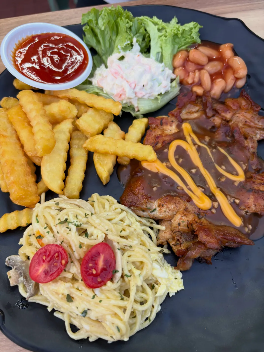 Chicken chop under mushroom gravy with carbonara spaghetti, crinkle fries and coleslaw