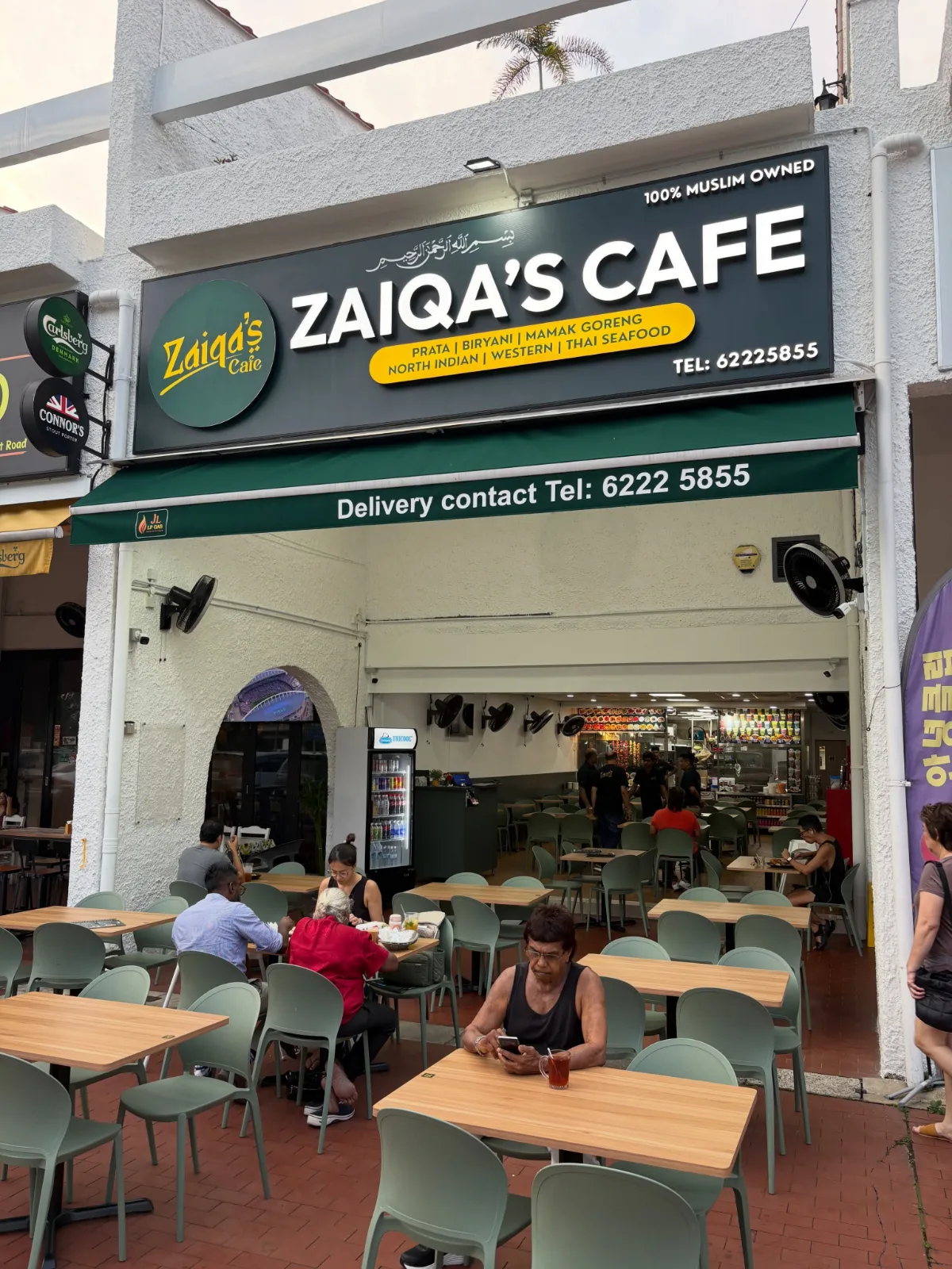 The Zaiqa’s Cafe shopfront on East Coast Road, sage-green tables set out under the green awning below the signboard